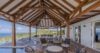 Shaded outdoor lounge at a St Barts villa rental with panoramic ocean and hillside views.