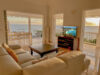 Bright villa living room with ocean-view terrace and sunset over St Barts