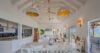 Open-plan dining and living area in a luxury St Barts villa with high ceilings and sea views.