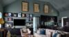 Elegant living room with art-lined wall, plush seating and open kitchen in luxury St Barts villa rental