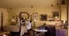 Elegant suite at St Barts villa with four-poster bed, classic artwork, and kitchenette