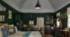 Elegant bedroom with dark green walls, cozy seating and vintage décor in St Barts villa rental