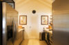 Compact kitchen in St Barts vacation rental with stainless steel appliances and vaulted ceiling