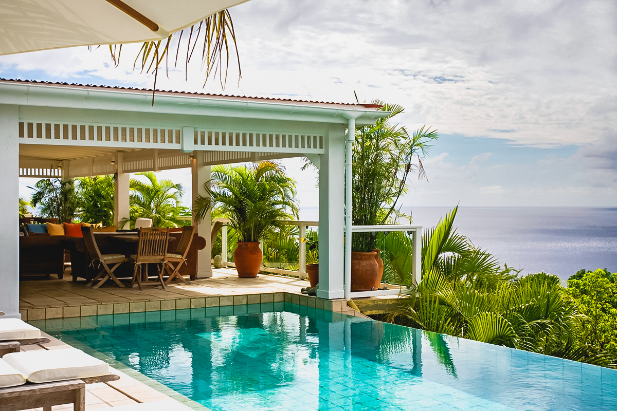 Infinity pool at private villa rentals St Barts with ocean view and shaded terrace
