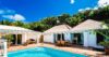 St Barts villa rental with turquoise pool, sunlit terrace, outdoor dining area and tropical garden backdrop