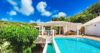 Private St Barts villa with sparkling pool, sun deck, lush tropical greenery and shaded outdoor lounge