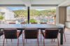 Modern hillside villa in St Barts with sleek architecture, palm trees, and stone walls, part of luxury villas St Barths