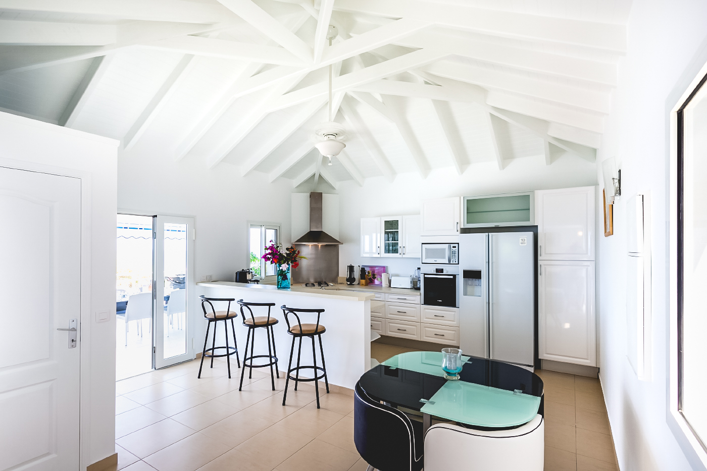 Spacious kitchen with breakfast bar, high ceilings, and modern appliances at St Barthelemy villa rental