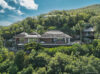 Hilltop St Barts villa surrounded by lush tropical greenery with panoramic views and private terraces.