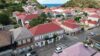 Aerial view of Gustavia with red-roofed houses and Caribbean Sea backdrop in St Barts