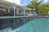 Private villa pool with shaded terrace and tropical palm garden in St Barts