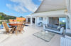Stylish St Barts villa dining area opening to a sunlit terrace with sweeping Caribbean views.