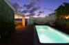 Glowing private pool at a St Barts villa rental illuminated under twilight skies.