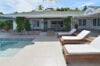 Villa exterior with mosaic-tiled pool, shaded pergola, and sun loungers in a private St Barts vacation rental.