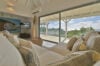 Villa living room with plush sofa, wall art, and sliding doors to terrace with ocean views in St Barts vacation rental.