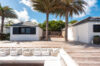 Spacious deck at st barts villa with palm trees and outdoor lounge seating.