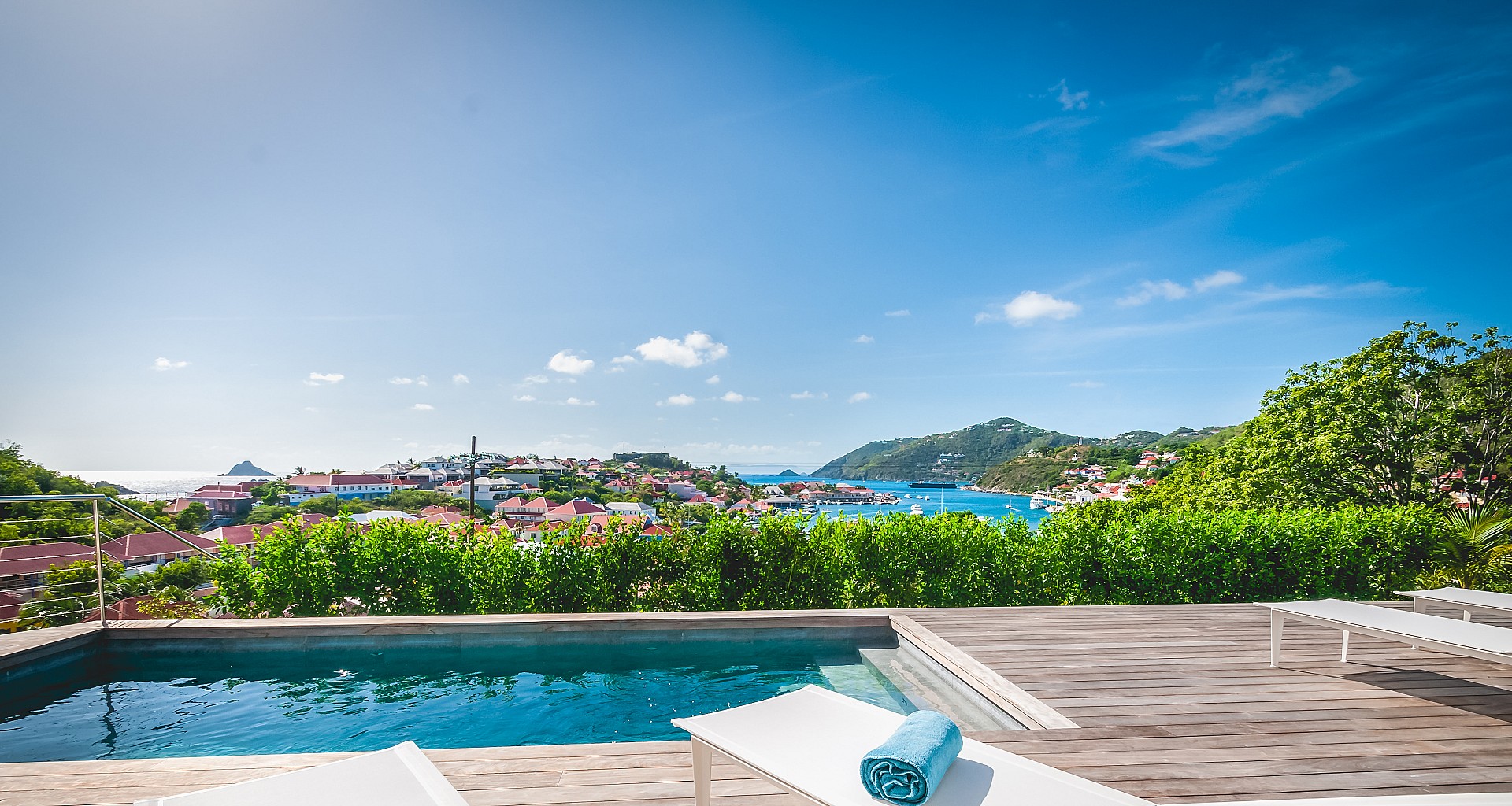 Infinity pool with wooden deck and panoramic Caribbean Sea views at luxury villa rental in St Barts