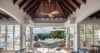 Sophisticated living room with vaulted ceiling opening to a terrace and ocean views at a St Barts villa.