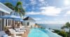 Infinity pool with sun loungers and umbrellas overlooking the Caribbean Sea at a luxury villa in St Barts