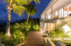 Evening ambiance at a luxury St Barts villa with illuminated terrace and serene sea horizon.