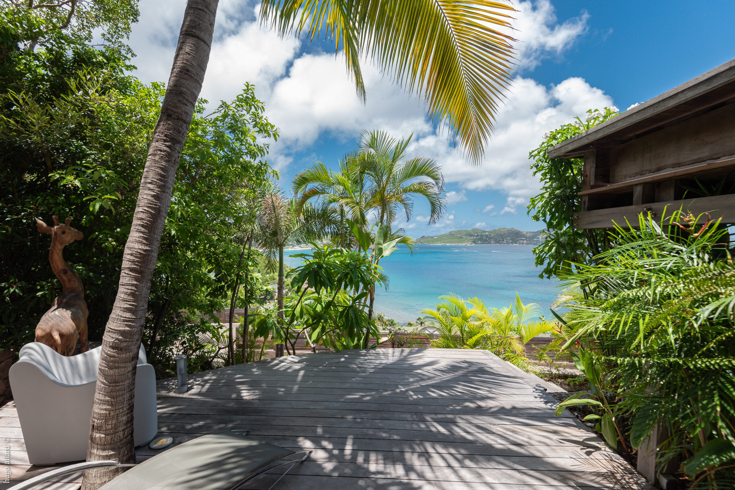 The outdoor area features a giraffe statue at Villa Safari in St. Barts.