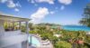 Luxury villa in St Barts with panoramic ocean views, tropical gardens, and sunlit pool terrace.