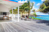Spacious oceanfront deck with sun loungers and shaded dining area at private villa rental in St Barts