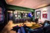 Art-inspired lounge in a St Barts villa with bold wall art, eclectic furnishings, and dramatic lighting for a modern creative vibe.