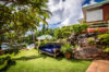 Lush garden at St Barts villa with shaded seating and tropical greenery