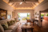 Cozy living room at St Barts villa with vaulted ceiling and ocean-view balcony