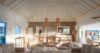 Bright open-plan living room in a St Barts villa with vaulted ceiling, natural décor, and seamless indoor-outdoor flow.
