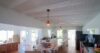 Spacious kitchen with patterned tile island, terracotta floors, and rustic wooden accents in a traditional St Barts villa rental.