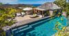 Luxury St Barts villa with long infinity pool, shaded pavilion, and hillside deck overlooking the Caribbean Sea.
