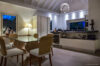 Elegant dining area with modern kitchen and night view at St Barthelemy villa rental