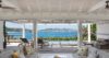 Covered outdoor lounge with sofas and ocean view at luxury villa in St Barts