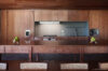 Minimalist wood kitchen with long counter in contemporary St Barts villa rental