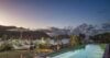 Long infinity pool with sun loungers, tropical garden, and ocean views at St Barts luxury villa
