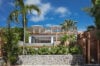 Modern villa surrounded by tropical gardens and palm trees in St Barths.