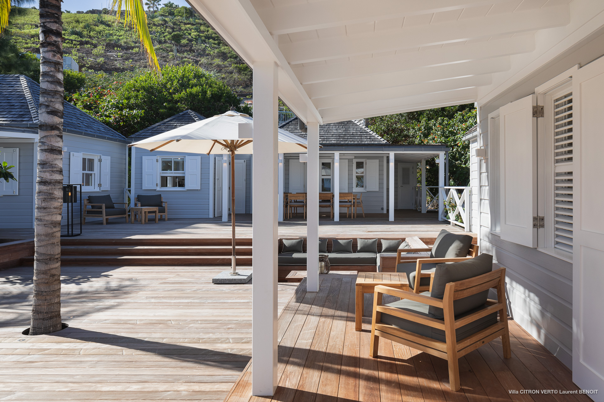 Wooden deck terrace with lounge chairs and shaded seating at a private villa in St Barts.