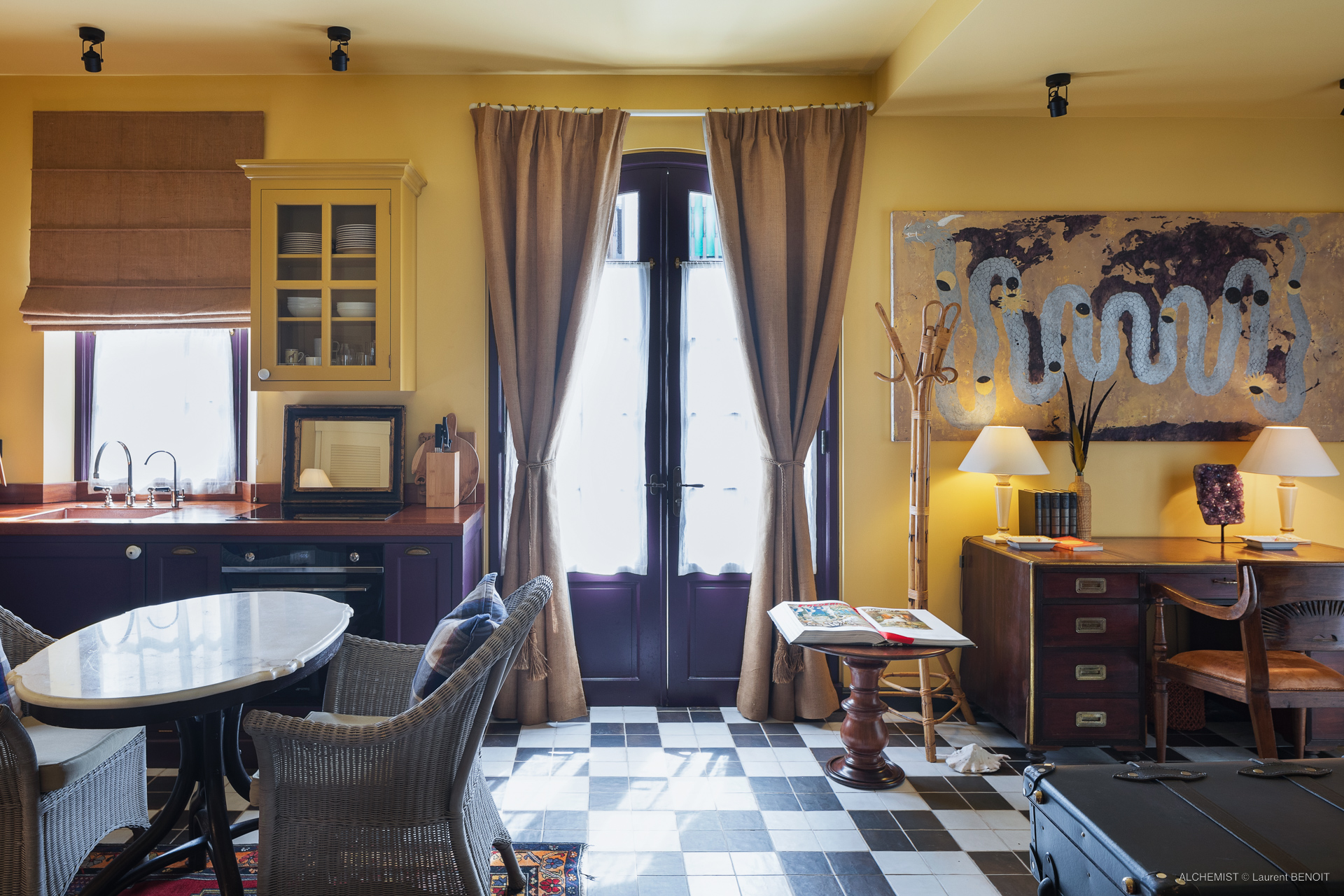 Eclectic suite at St Barts villa with work desk, dining table, and vintage décor.