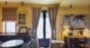 Stylish suite at St Barts villa with writing desk, vintage artwork, and dining corner