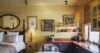 Elegant suite at St Barts villa with kitchenette, wall art, and cozy bedroom corner”