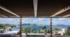 Shaded pool terrace at a St Barts villa with lounge beds overlooking the ocean and nearby islands