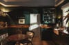 Charming kitchen with dark wood cabinetry, farmhouse sink and warm lighting in St Barts villa rental