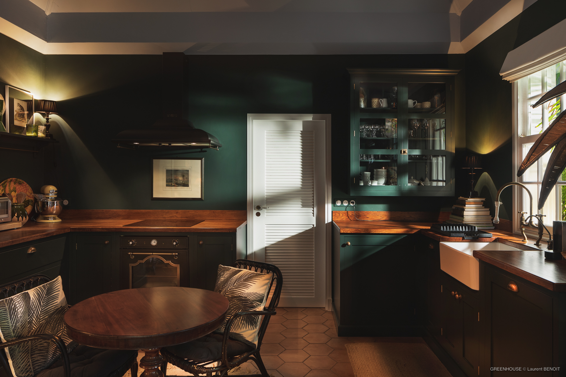 Charming kitchen with dark wood cabinetry, farmhouse sink and warm lighting in St Barts villa rental