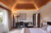 Bedroom with wooden ceiling, desk, and soft lighting at luxury villa in St Barts