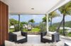 Shaded terrace with cushioned chairs and garden view at luxury villa in St Barts