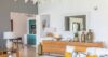 Elegant living space in a St Barts villa with modern décor, golden accents, and soft natural light.