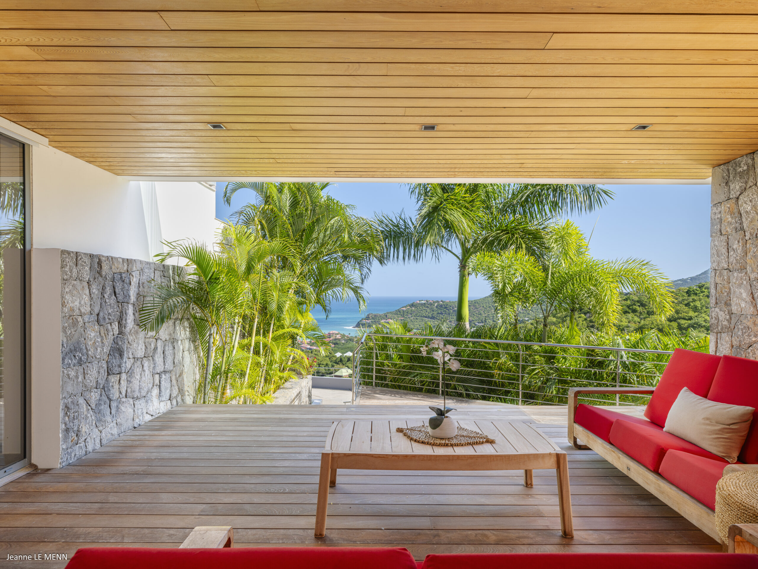 Terrace at Villa Loukoko in St Barts overlooking the ocean with open-air seating.