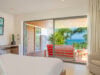 Ocean-view bedroom at Villa Loukoko in St Barts with king bed and wide glass doors.